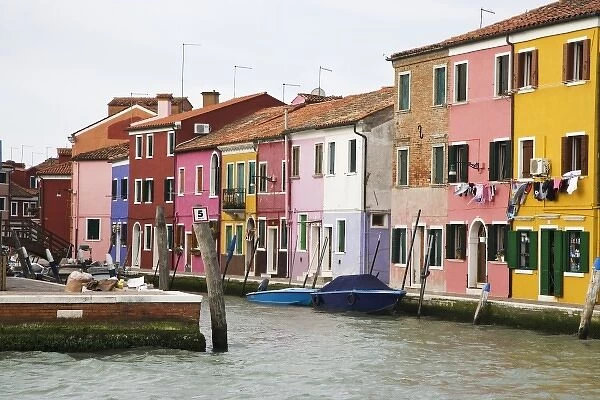 Europe, Italy, Burano. Boats and colorful homes along a canal. Credit as: Dennis