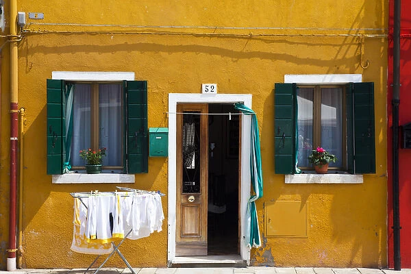 Europe; Italy; Burano; Bright Colored Home with Laundry Out