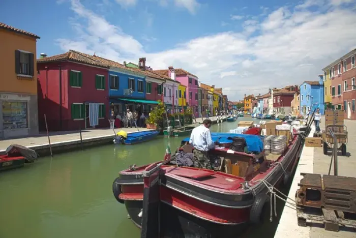 Framed Print : Europe; Italy; Burano; Bright Colored Homes Along the Canal, Man Delivery Supplies