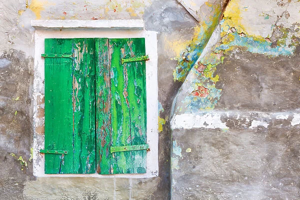 Europe, Italy, Burano. Close-up of weathered window shutters