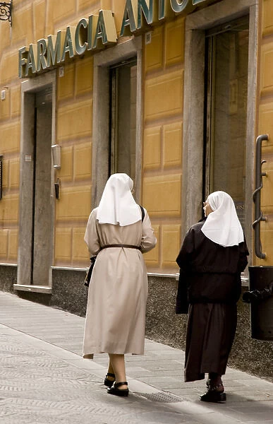 Europe, Italy, Camogli. Two nuns walk along the Via Republica area of town. Credit as