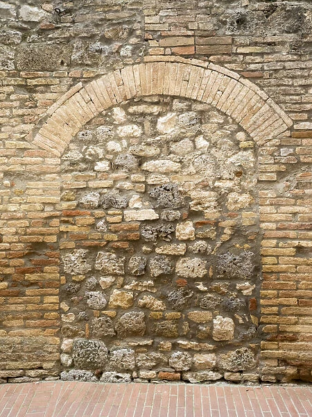 Europe, Italy, Chianti. Old doorway that has been closed off with stone in the town of