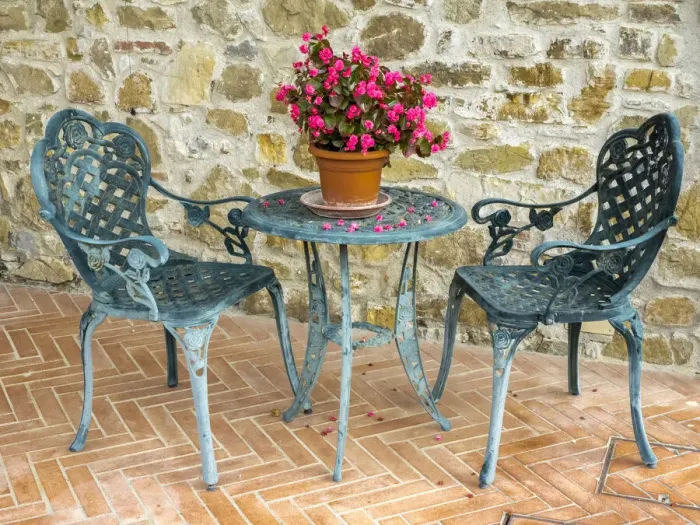 Framed Print : Europe, Italy, Chianti. Table and chairs with a flowering begonia in the center against a Framed Print : Europe, Italy, Chianti. Table and chairs with a flowering begonia in the center against a