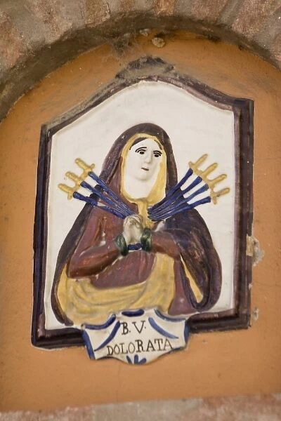 Europe, Italy, Dozza. Ceramic plaque of the Virgin Mary with seven swords piercing her heart