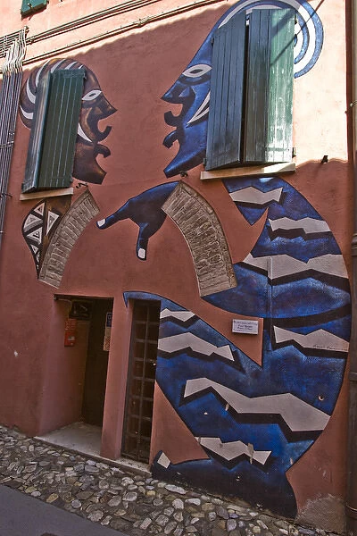 Europe, Italy, Dozza. House with painted mural of African figures. Credit as: Wendy