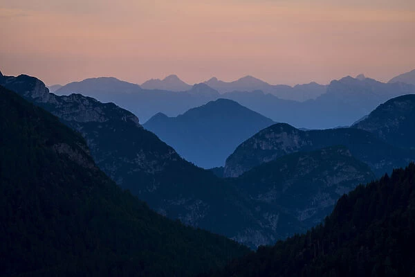 Europe, Italy, Friuli Venezia Giulia. Foggy Monte Lussari mountain at sunset