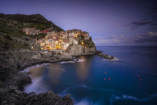 Europe, Italy, Manarola. Sunset coastline with town and ocean