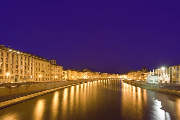 Europe, Italy, Pisa. Lights reflect on the Arno River that runs through the town of Pisa