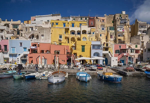 Europe, Italy, Procida. City houses and boats in Marina Corricella