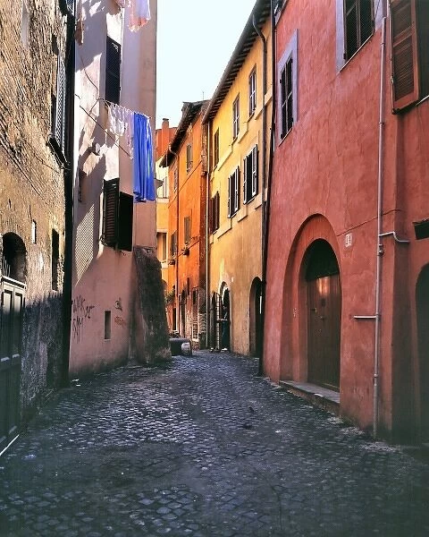 Europe, Italy, Rome. Laundry dries above a colorful street in the Trastevere section of Rome, Italy