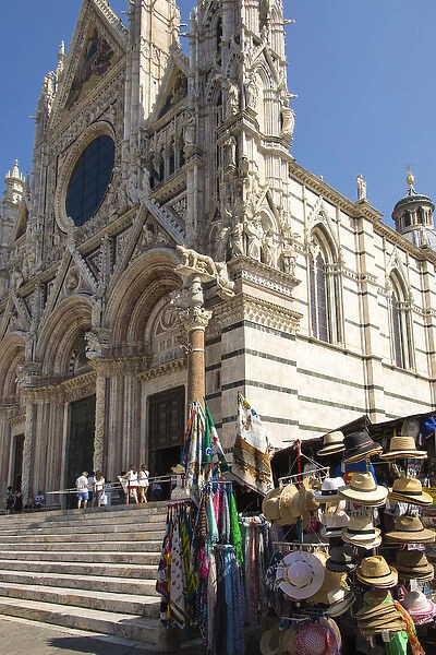 Europe, Italy, Siena. Ornate Duomo facade surrounded by souvenir stands