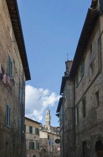 Europe, Italy, Tuscany, Siena, Midieval Alleyway with Torre del Mangia in the Background