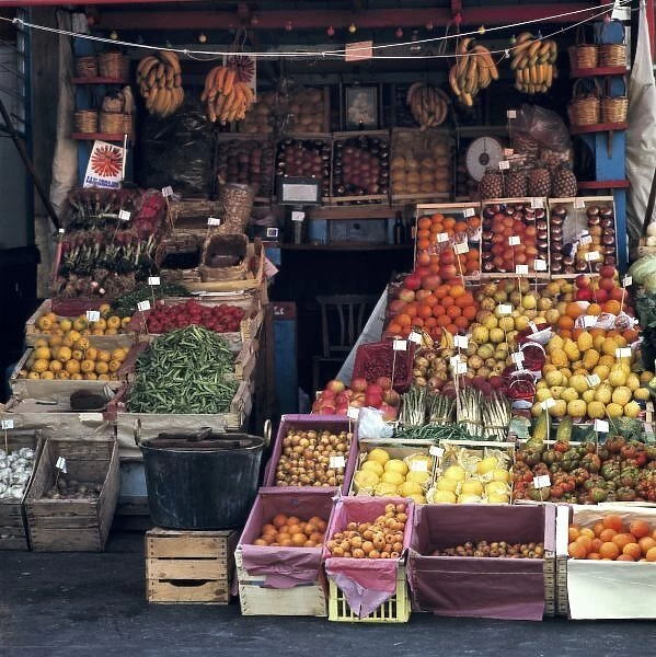 Europe, Italy, Venice area. Colorful fruits and vegetables fill a produce vendors stand near Venice