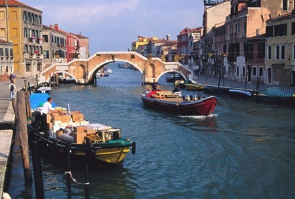 Europe, Italy, Venice. Boats bringing in supplies by way of Venice canal