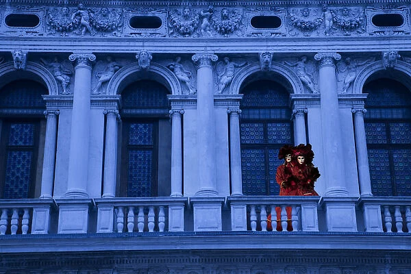 Europe, Italy, Venice. Composite of couple on balcony in Carnival costumes. Credit as