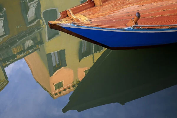 Europe, Italy, Venice. Gondola and building reflect in canal