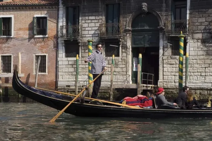 Framed Print : Europe, Italy, Venice. A gondolier strikes a pose on his gondola