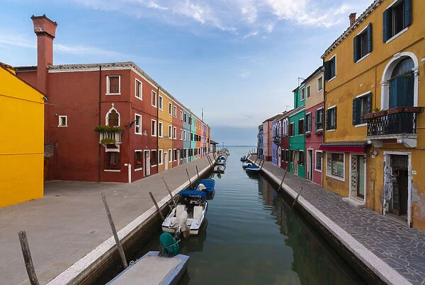 Europe, Italy, Venice. Houses and boats on canal in Burano