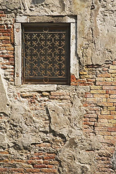 Europe, Italy, Venice. Ornate metalwork window covering along a side street. Credit as