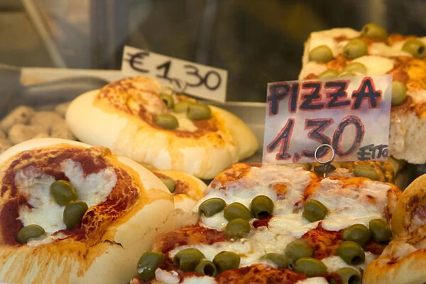 Europe, Italy, Venice. Pizza slices for sale seen through a store window. Credit as