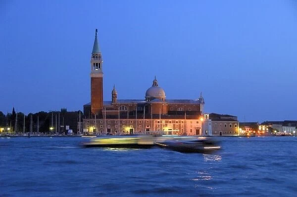 Europe, Italy, Venice. Water taxis blured at night. UNESCO World Heritage Site