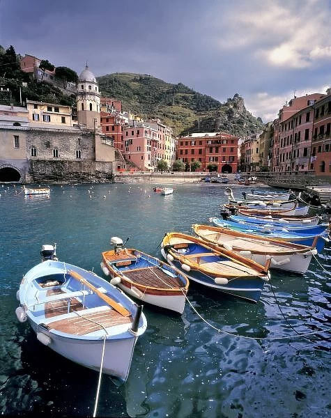 Europe, Italy, Vernazza. Brightly painted boats line the dock at Vernazza Harbor