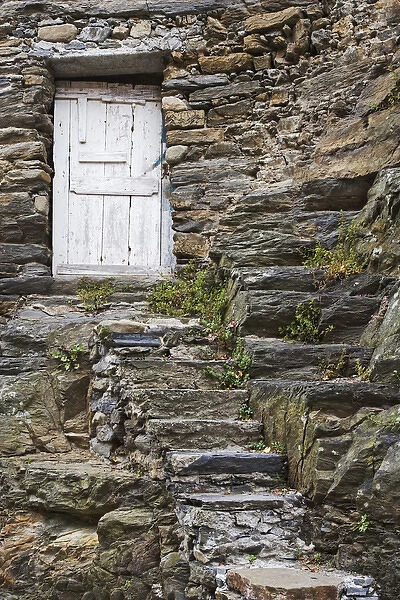 Europe, Italy, Vernazza. Rock steps lead to an old wooden door