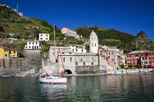 Europe; Italy; Vernazza; Sail Boat landing at the City and Church of Santa Margherita