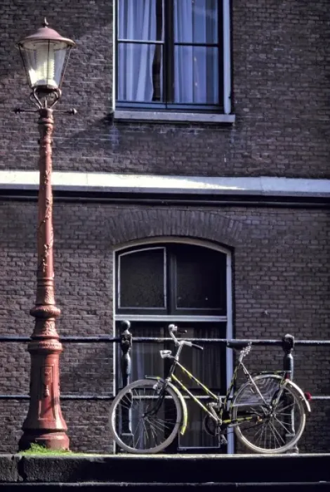 Framed Print : Europe, Netherlands, Amsterdam. Near a striking red lampost, a bicycle waits for its rider Framed Print : Europe, Netherlands, Amsterdam. Near a striking red lampost, a bicycle waits for its rider