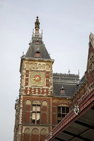Europe, Netherlands, Amsterdam. Looking up at clock tower of Central Station