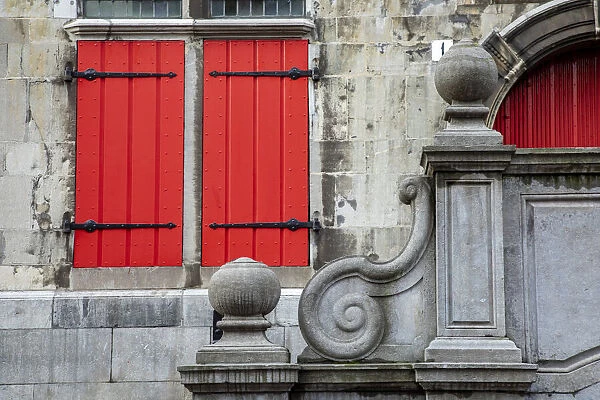 Europe, Netherlands, The Hague. Red shuttered window and stone scroll on 16th century Old
