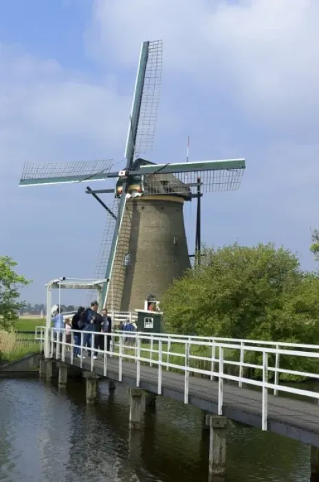 Framed Print : Europe, Netherlands, Holland, Kinderdijk, American tourist visit a windmill open