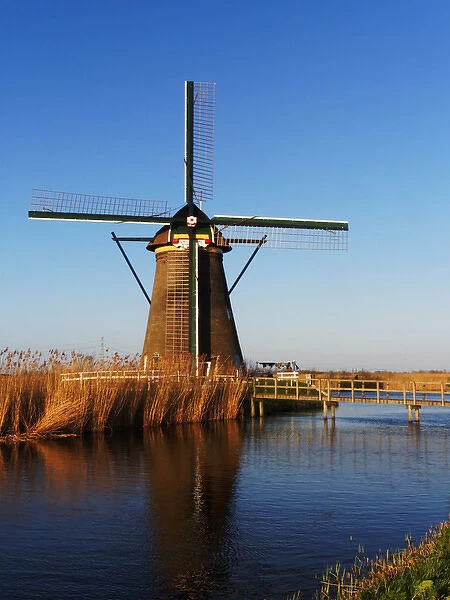 Europe; Netherlands; Kinderdijk; Windmills with Evening light along the Kinderdijk canal