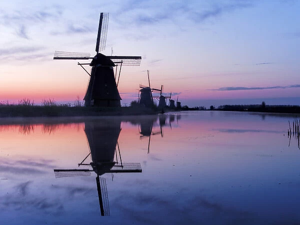 Europe; Netherlands; Kinderdijk; Windmills at Sunrise along the canals of Kinderdijk
