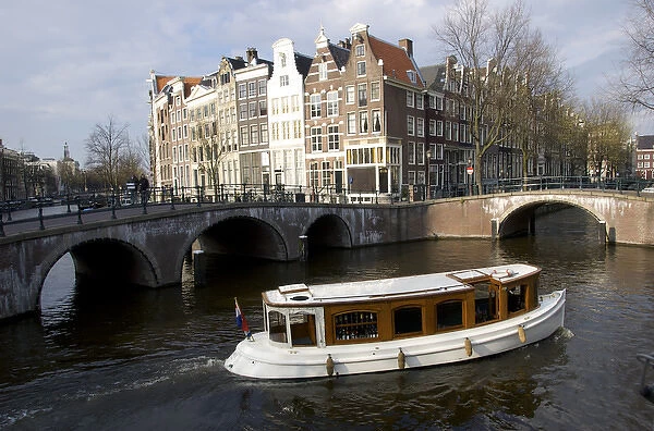 Europe, Netherlands, North Holland, canal boat in Amsterdam canal