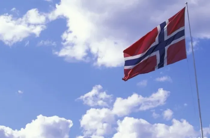 Framed Print : Europe, Norway, Lillehammar. National flag flying on a summer day