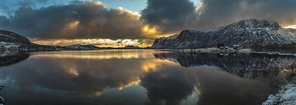 Europe, Norway. Snow covered mountains surround the still waters near Leknes on Vestvagoy