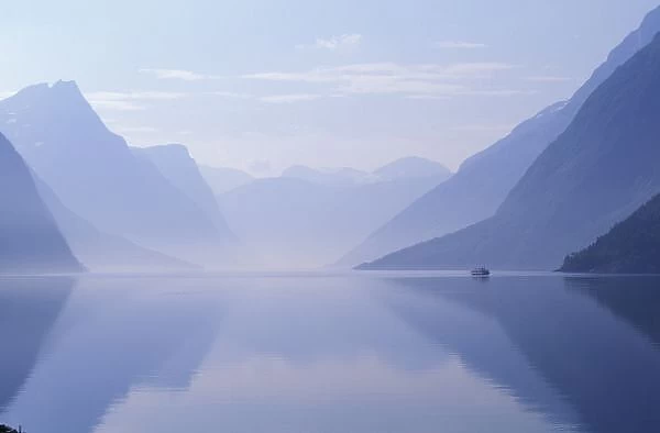 Europe, Norway. Vertical walls reflected in calm Eikesdalsvetnet near the village of Osen