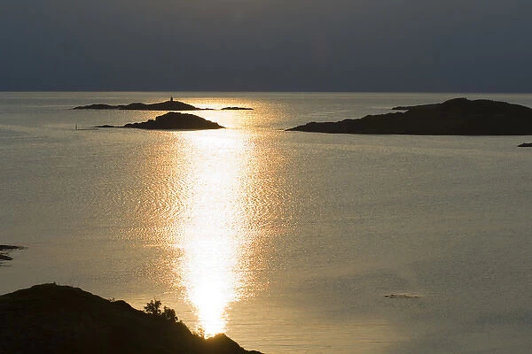 Europe, Norway, Vesteralen. Midnight sun reflecting in the Atlantic Ocean