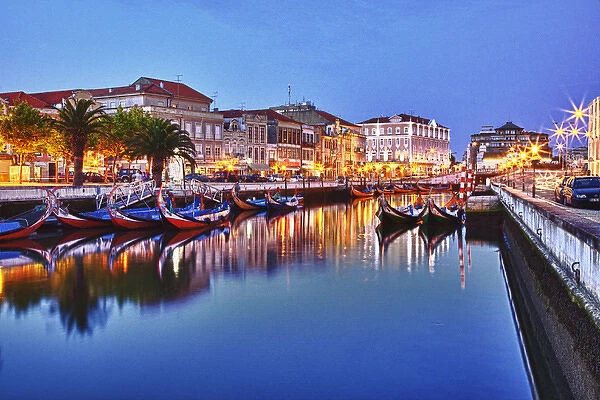 Europe; Portugal; Averio; Moliceiro Boats Along the main canal of Averio With Night Lights