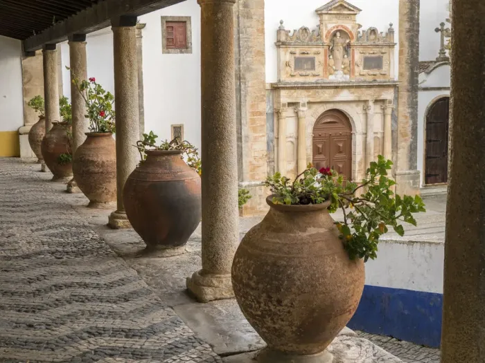 Framed Print : Europe, Portugal, Obidos. Ceramic pots adorn a ledge along a building