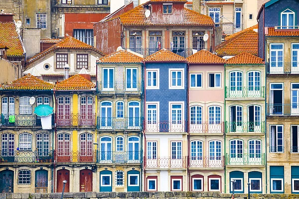 Europe, Portugal, Porto. Colorful building facades next to Douro River. Credit as