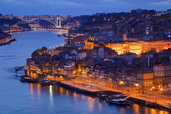 Europe, Portugal, Porto. View of city and harbor at night