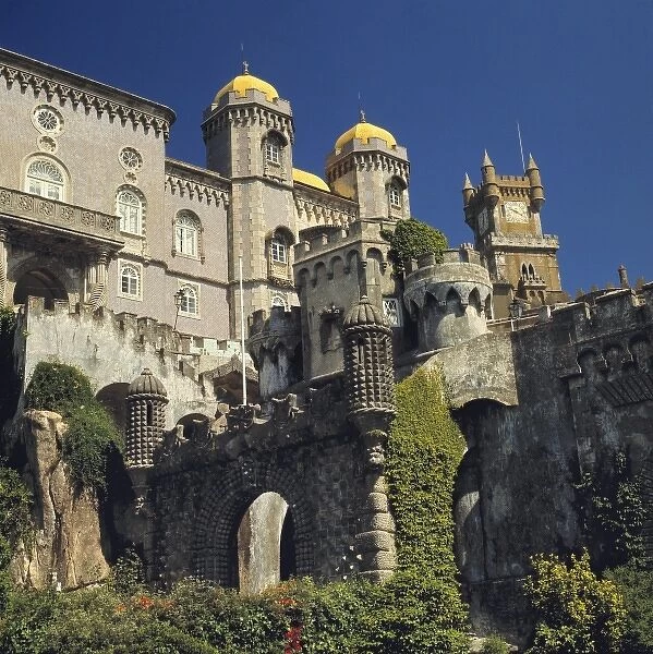 Europe, Portugal, Sintra. The yellow roofs of the towers of Pena Palace shine in the sun in Sintra