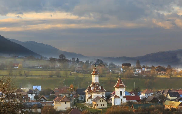 Europe, Romania, Bucovina, Campulung Moldovenesc, Fall colors. Churches in valley