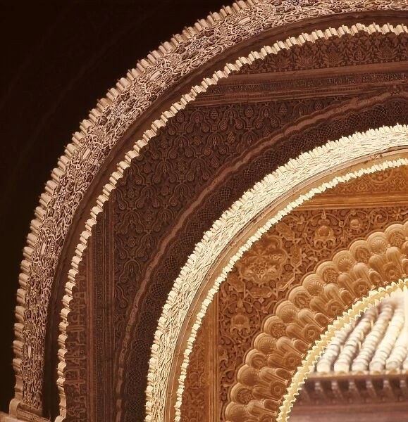 Europe, Spain, Granada. Light reveals intricate details in these carved archways