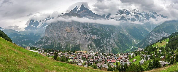 Europe, Switzerland, Bernese Oberland. Panoramic of mountains and village in valley