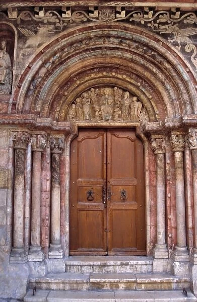 Europe, Switzerland, St. Ursanne. The ornate door to the Collegiate Church was begun