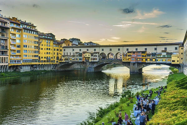 Evening dinner party by the Arno River, Ponte Vecchio, Florence, Tuscany, Italy