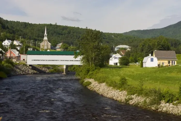 Framed Print : Fauberg covered bridge and the village of l Anse St. Jean in the Saguenay River